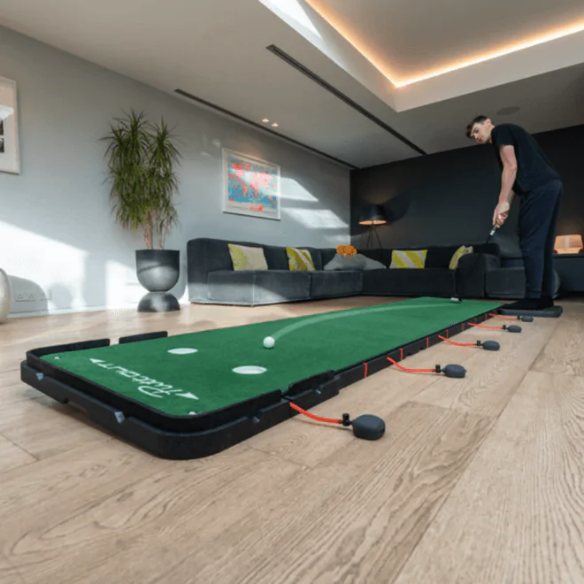 The PuttOut AirBreak Max adjustable putting platform set up along a living room floor